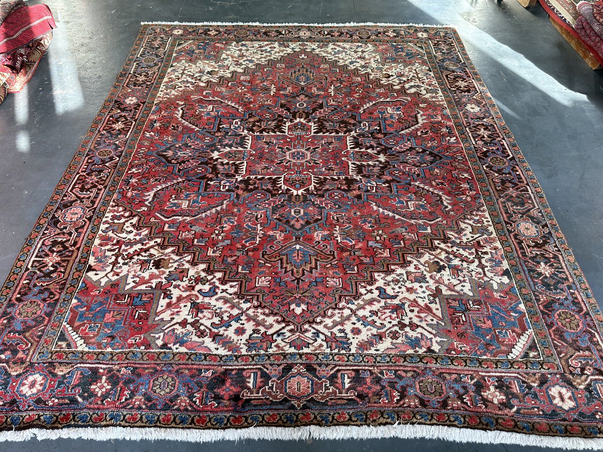 This stunning Gerevan rug with its warming red background and bold geometric design is the perfect companion to a living room with a fire place Enquire -> info@bakhtiyar.com #London #shopsmall #rug