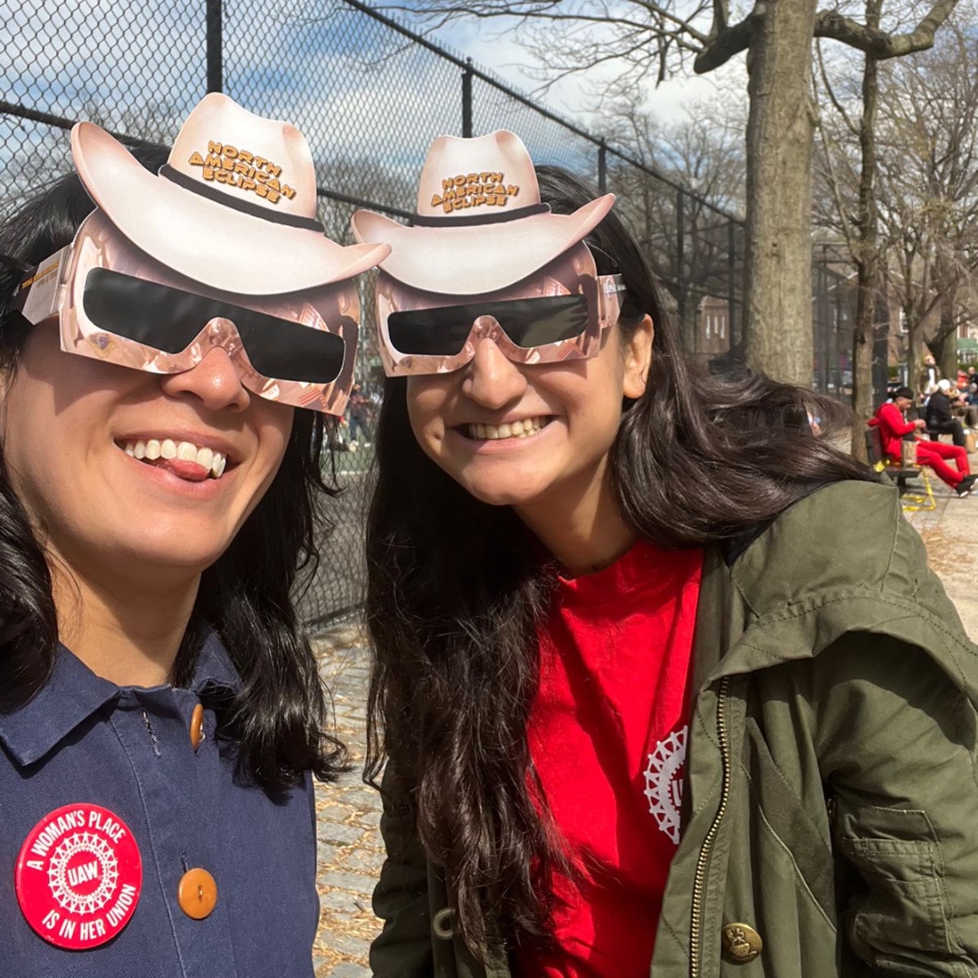 Claire Valdez from UAW Local 2110 and Anila Gill, an organizer with @UAWRegion9A, viewing the eclipse in NYC. #Solidarity #Eclipse2024 #StandUpUAW