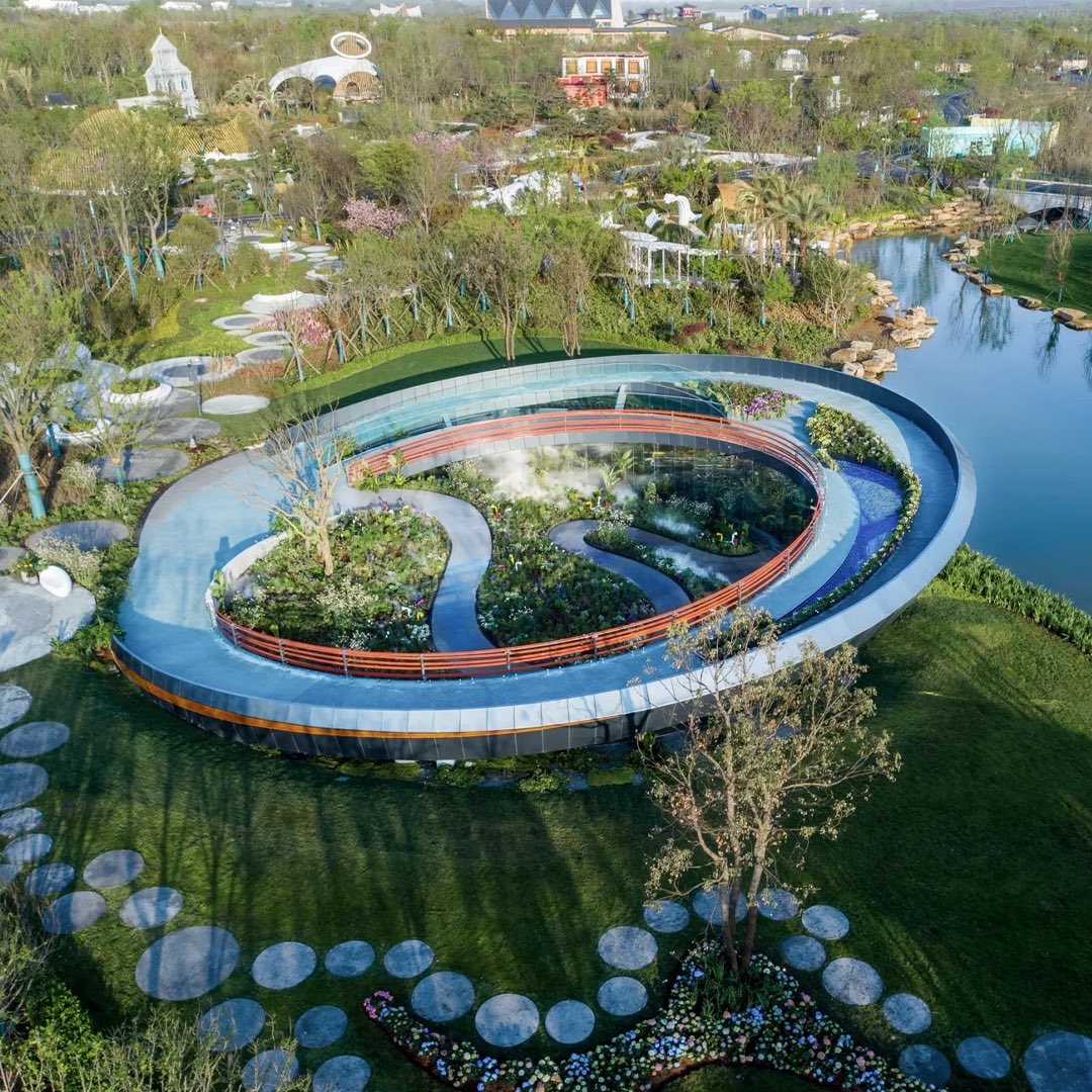 parametricarch's tweet photo. Shenzhen Garden, designed by Fangxing Design, intertwines the site’s characteristics with its structure, forming a vertical circular circulation line that enhances the visitor’s journey through the garden. The garden’s theme, “Symbiosis Ring,” highlights the interconnectedness of people, city, and nature—the first layer of symbiosis.

Positioned at the center of the exhibition garden, Shenzhen Garden adopts a ring-like stance towards its surroundings, symbolizing the coexistence of exhibition gardens—the third layer of symbiosis. Leveraging the garden’s meandering pathways and circular inner mirror structure, the design offers visitors a reflective experience upon entry. Through the use of one-way mirror materials, the visual experience is heightened, creating an intriguing interplay between internal and external environments along the pathway.

📸 Chen Jie

#parametricarchitecture #computationaldesign #shenzhengarden #landscapedesign