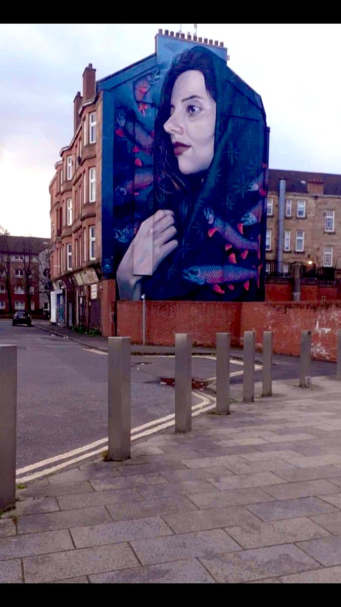 I walked past this mural today. St Thenue being guided across the Firth of Forth by a shoal of trout. Her shawl features 29 motifs in tribute to 29 women from Glasgow’s east end who died in Templeton’s carpet factory in 1889 when a wall collapsed into the weaving shed. #Glasgow