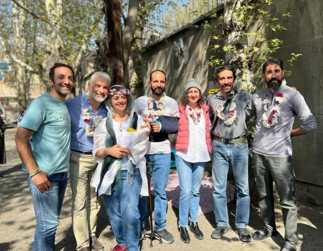 Smiling for the cameras, Iranian conservationists celebrate their freedom by taking a group photo in remembrance of the collective ordeal they shared. All they wanted was to save Iran's endangered Asiatic cheetahs but were slandered and tried for espionage. They are now all free.