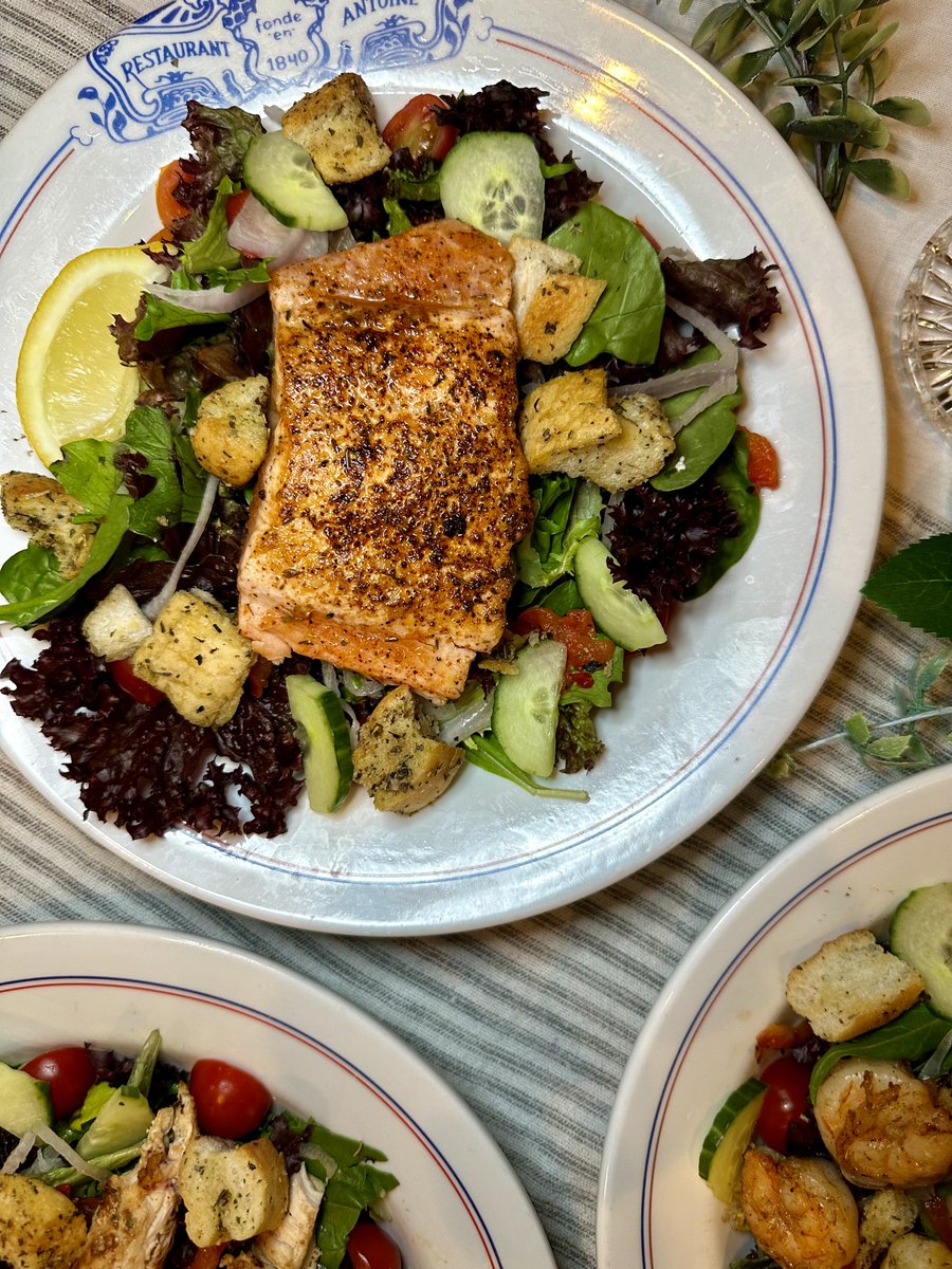 Our Saint Louis Street Salad with Honey Glazed Atlantic Salmon is going to be your new lunch favorite! #antoinesnola #antoines1840 #saintlouisstreetsalad #honeyglazedsalmon #atlanticsalmon #salmon #lunch #lunchtime #salad