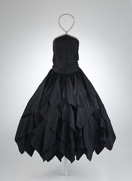 This week's #TwentiesTuesday garment is one of my personal favourites. Lanvin's 1928 'La Traviata' dress is constructed from petals of black taffeta applied to a skirt base of silk tulle. The bodice is delicately decorated with rhinestone embroidery. @metmuseum #fashionhistory