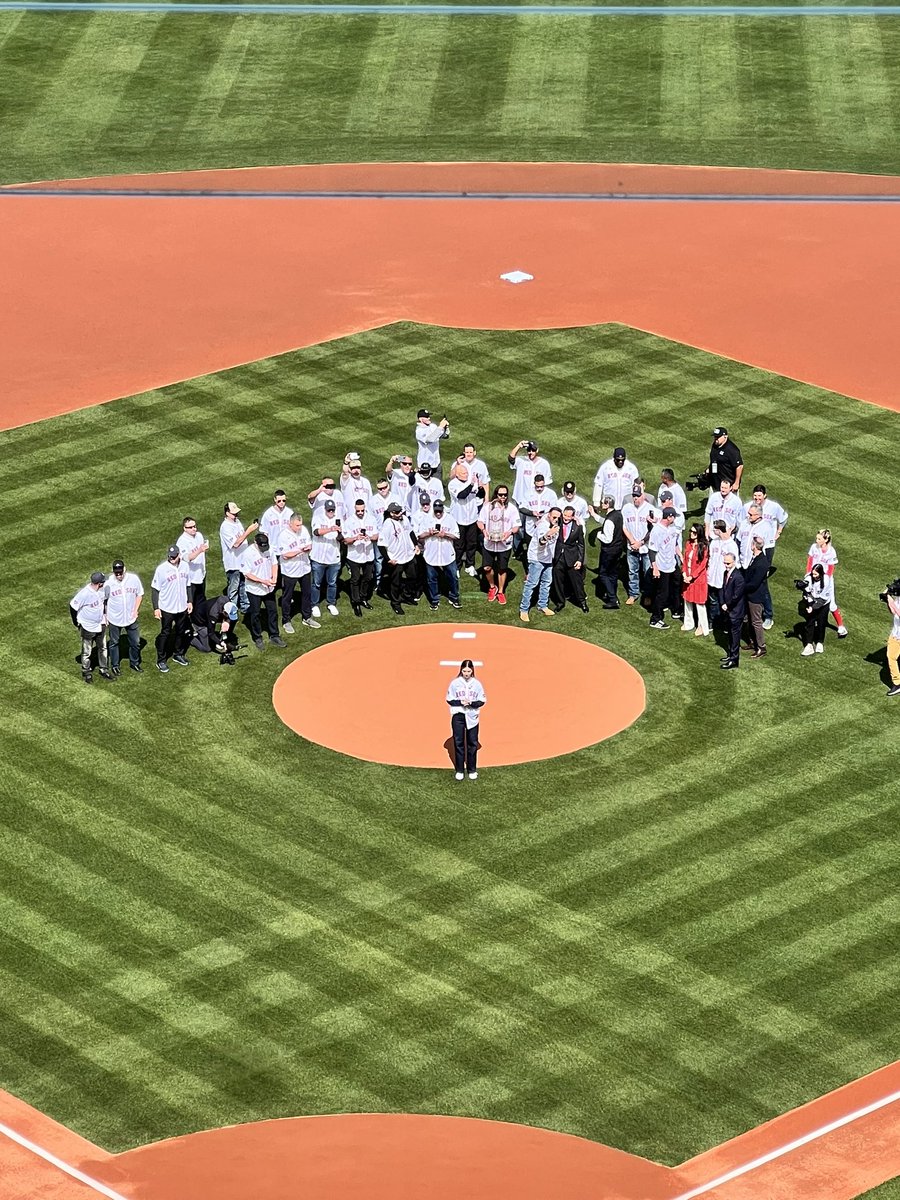 Brianna Wakefield, surrounded by her father’s 2004 teammates, throws out the first pitch at today’s game.