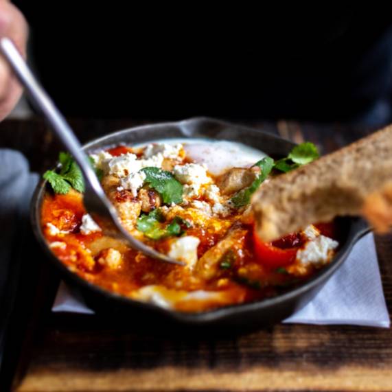 Indulge in the essence of Israeli cuisine with Shakshuka! This iconic dish is a delicious blend of flavors influenced by the diverse cultures of the region. Picture perfectly poached eggs nestled in a spicy tomato and pepper stew—perfect for any time of day!