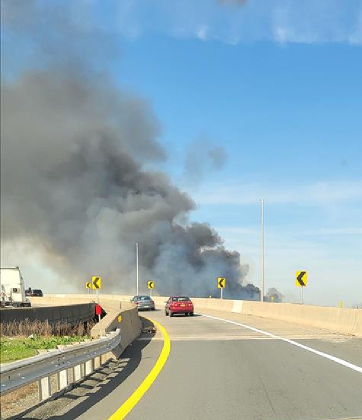 There is a large brush fire in Elizabeth that is creating a large smoke column visible over the westside of the city. For commuters, you may experience delays on the NJTP. @CityofBayonne