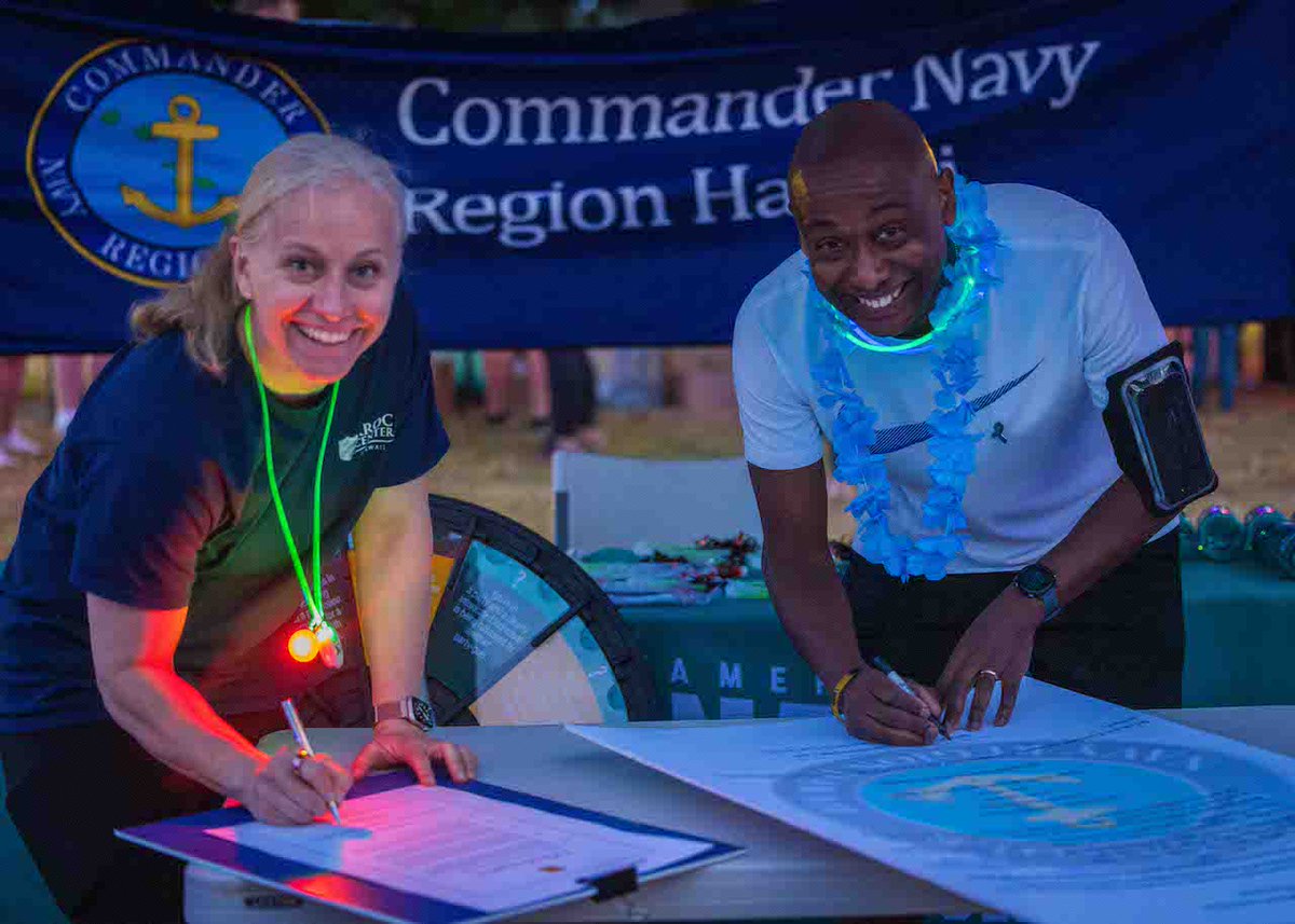 Rear Adm. Steve Barnett, commander, Navy Region Hawaii and Col. Michele Lo Bianco, @15thWing commander, sign the Sexual Assault Awareness and Prevention Month Proclamation during the annual Sexual Assault Awareness Prevention Month glow run at @JointBasePHH , April 5, 2024.