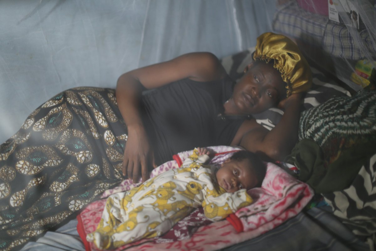 A woman and her young child lay under an insecticide-treated mosquito net in their home in #SierraLeone. Remember to always sleep under a mosquito net. It is one of the most effective ways to protect against malaria. #Endmalaria #foreverychild.