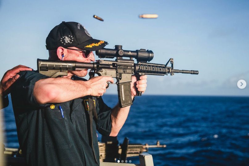 Commander of the USS John McCain firing his rifle with the optic on backwards. The scope is also covered. The post was later deleted by the U.S. Navy on all social media platforms.