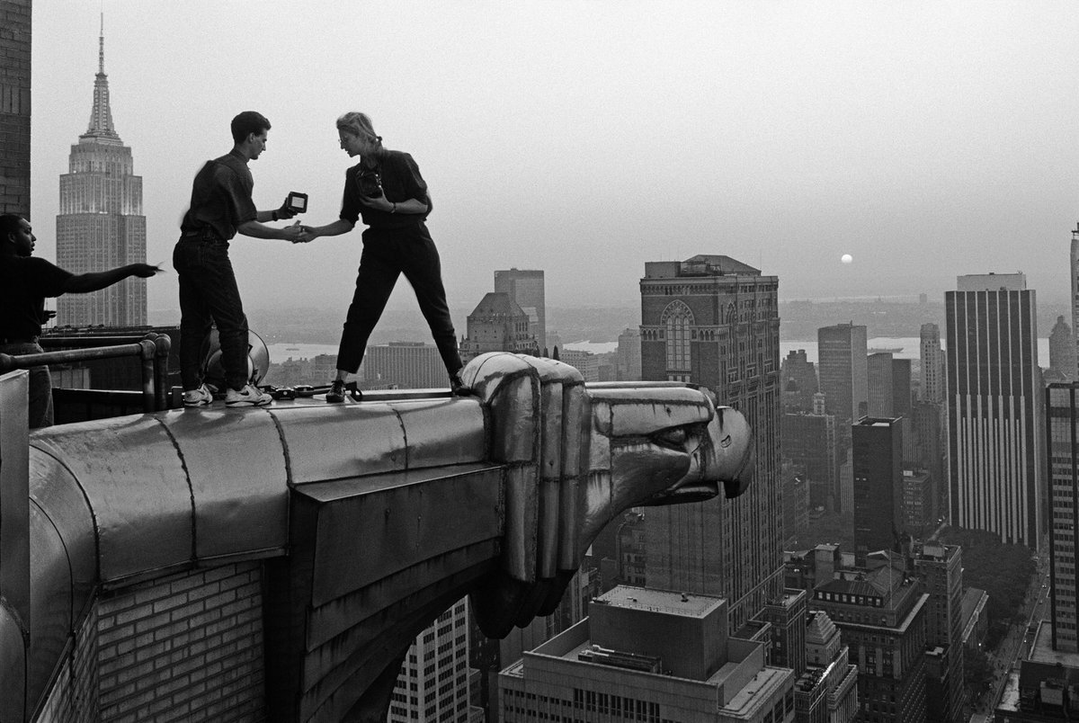 Annie Leibovitz and Assistant Robert Bean taking photographs from the Chrysler Building in 1991. She said at the time “I can’t help but feel that we’ll have Margaret Bourke-White’s shadow over us. But that’s nice; that’s really, really nice.” Photo by John Loengard.