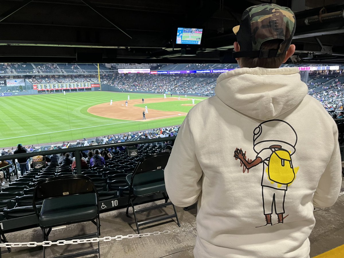 As I stood there watching the game, a lady approached me. She kindly asked to see the front of my hoodie, and as I turned around, she exclaimed how much she loved my AKU hoodie. She excitedly shared that her daughter is an artist, and we ended up having a delightful conversation…