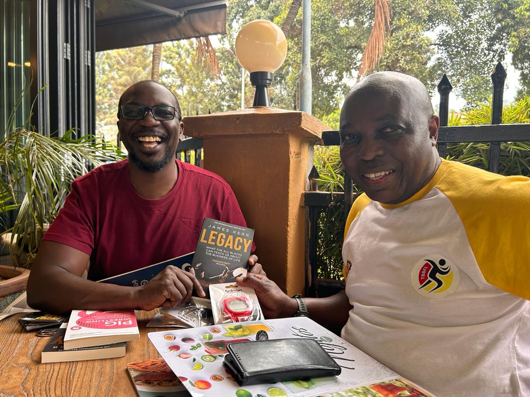 Sportsuganda256 CEO Handing Uganda Rugby Cranes National 7s Team Coach (Tolbert Onyango) a copy of the famous book on what makes the All Blacks so successful - Legacy (A must read!)SportsUganda