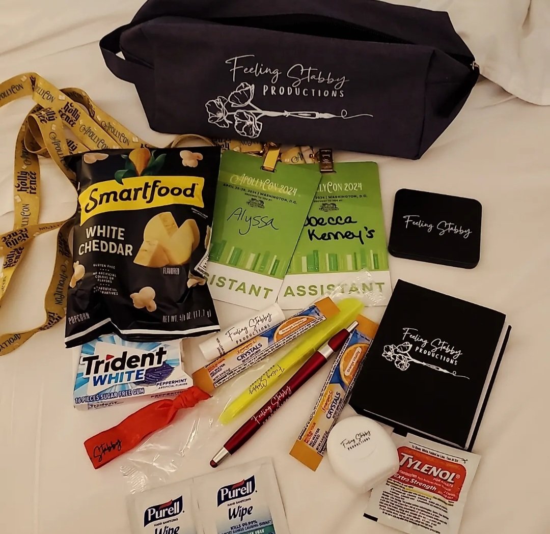 Got the cutest author welcome gift / survival kit when I checked in at Apollycon 2024! So thoughtful, from the snack, lip balm, chewing gum, and sanitizer wipes to the tiny mirror, vitamin packets, floss, and Tylenol! #Apollycon really cares about their authors. ❤️