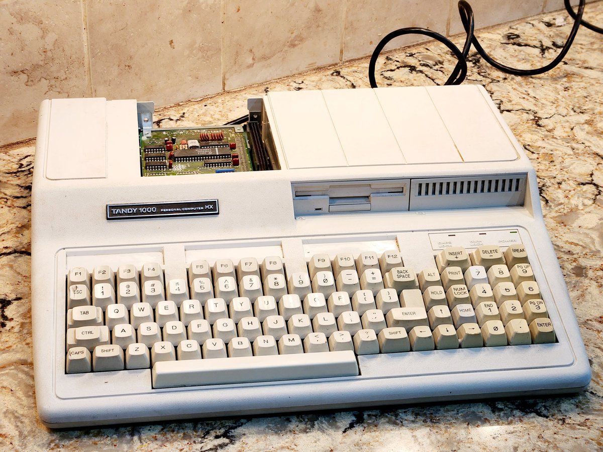 NYVintageMicros's tweet image. I rescued this Tandy 1000 HX  from ewaste, but the cable was clipped, keys knocked off, and cover lost. My friend Ian fixed it. Just need a cover now.

The HX released in 84', with DOS 2.11 stored in a ROM, 640k RAM, 16 color display, and 3 voice sound. 

#Tandy1000
#Radioshack