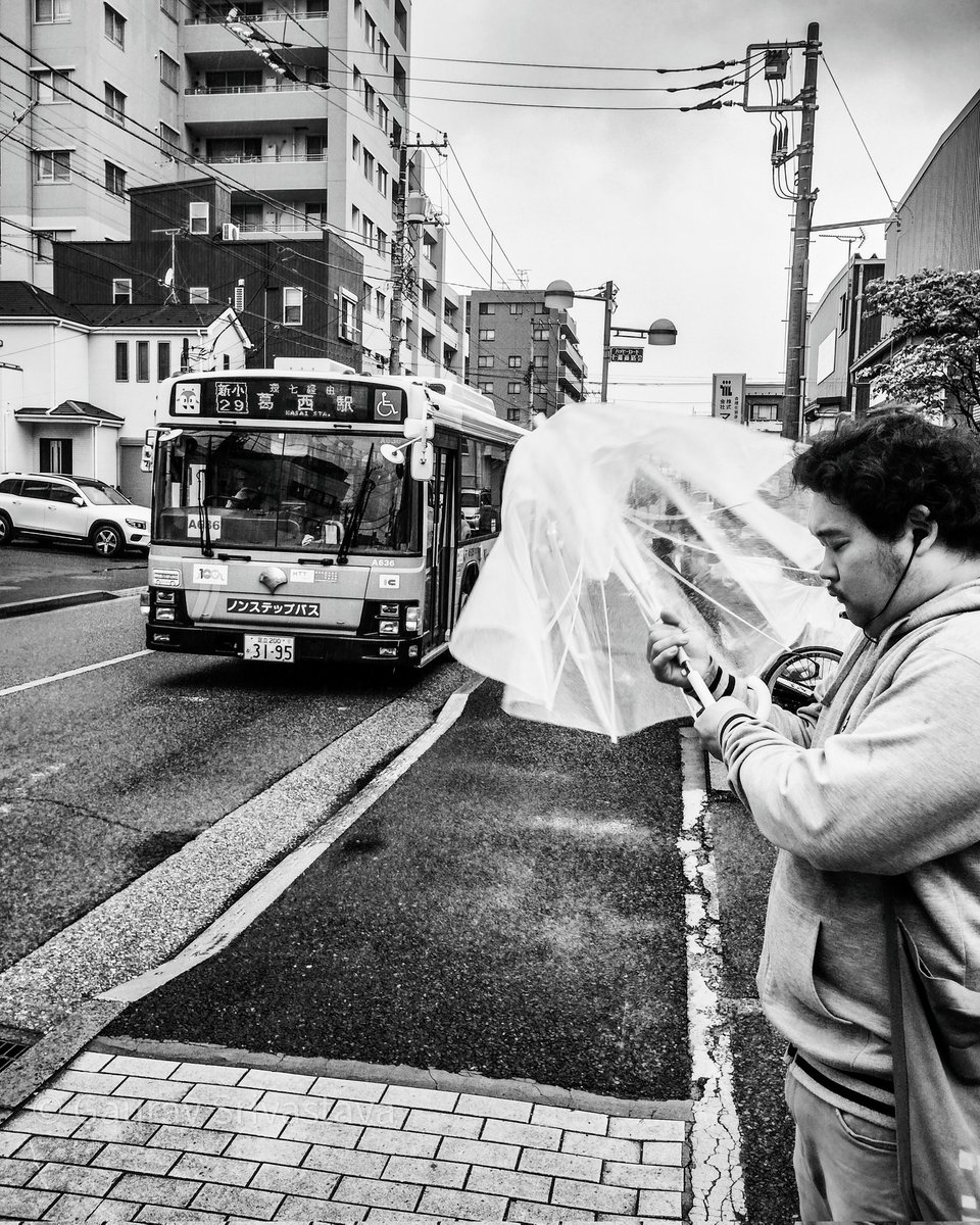 A man getting ready to board the bus for his daily commute on a rainy morning. #tokyo #japan #streetphotography #blackandwhite