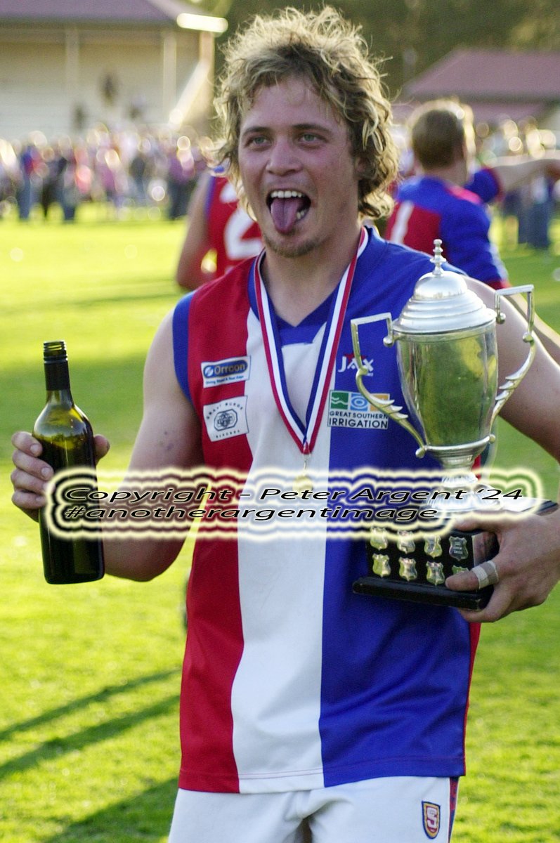 Quintessential Country Football 
One of my fav's from back in the day ... 
Barossa District premiership player Ryan Fromm from 2006, cup in one hand and a bottle of red in the other celebrating the Bulldogs BLG A grade flag at Kapunda Oval. 
#anotherargentimage