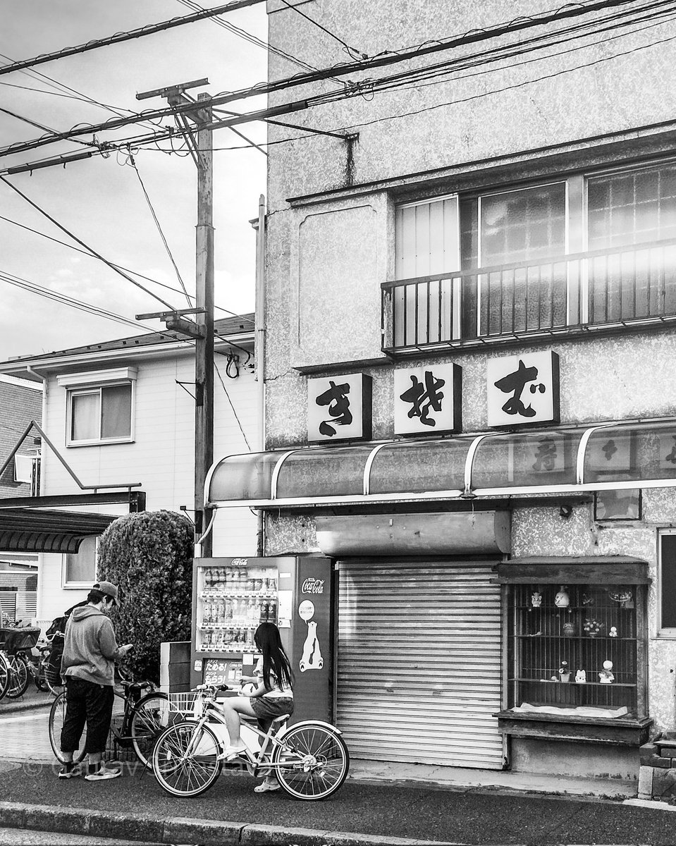 A father and daughter taking a drinks break during their cycling trip on a lazy Sunday afternoon. #streetphotography #blackandwhite #Japan #tokyo