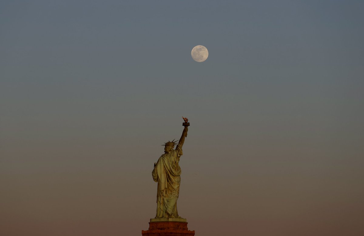 The Pink Moon rises behind the Statue of Liberty in New York City, Monday evening #newyorkcity #nyc #newyork #PinkMoon #moon #statueofliberty