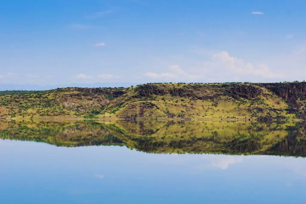 One of the most beautiful places in Kenya is Little Magadi, a hidden gem tucked away in the greater Magadi region.  
The lake, now a fifth of it's original size has some of the best reflections I've come across. 
The Maasai stands on the infamous Karigo Rock,

#Magadi  #Earthday
