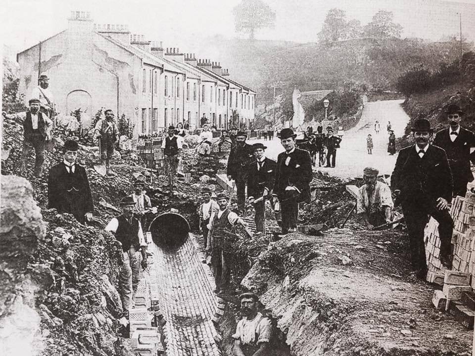 A photograph of people Moving the  River Fleet  underground at Daison Cottages ,near Penny's Cottage , on the Teignmouth Road taken in 1897