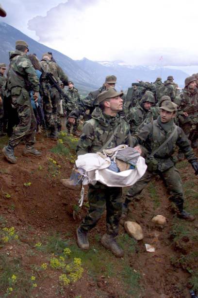 21 April 1999. An Italian NATO soldier carries a small refugee baby from Kosovo during an evacuation outside Kukes. 𝙿𝚑𝚘𝚝𝚘&𝙲𝚊𝚙𝚝𝚒𝚘𝚗 𝚋𝚢 𝙲𝙷𝚁𝙸𝚂𝚃𝙾𝙿𝙷𝙴 𝚂𝙸𝙼𝙾𝙽/𝙰𝙵𝙿