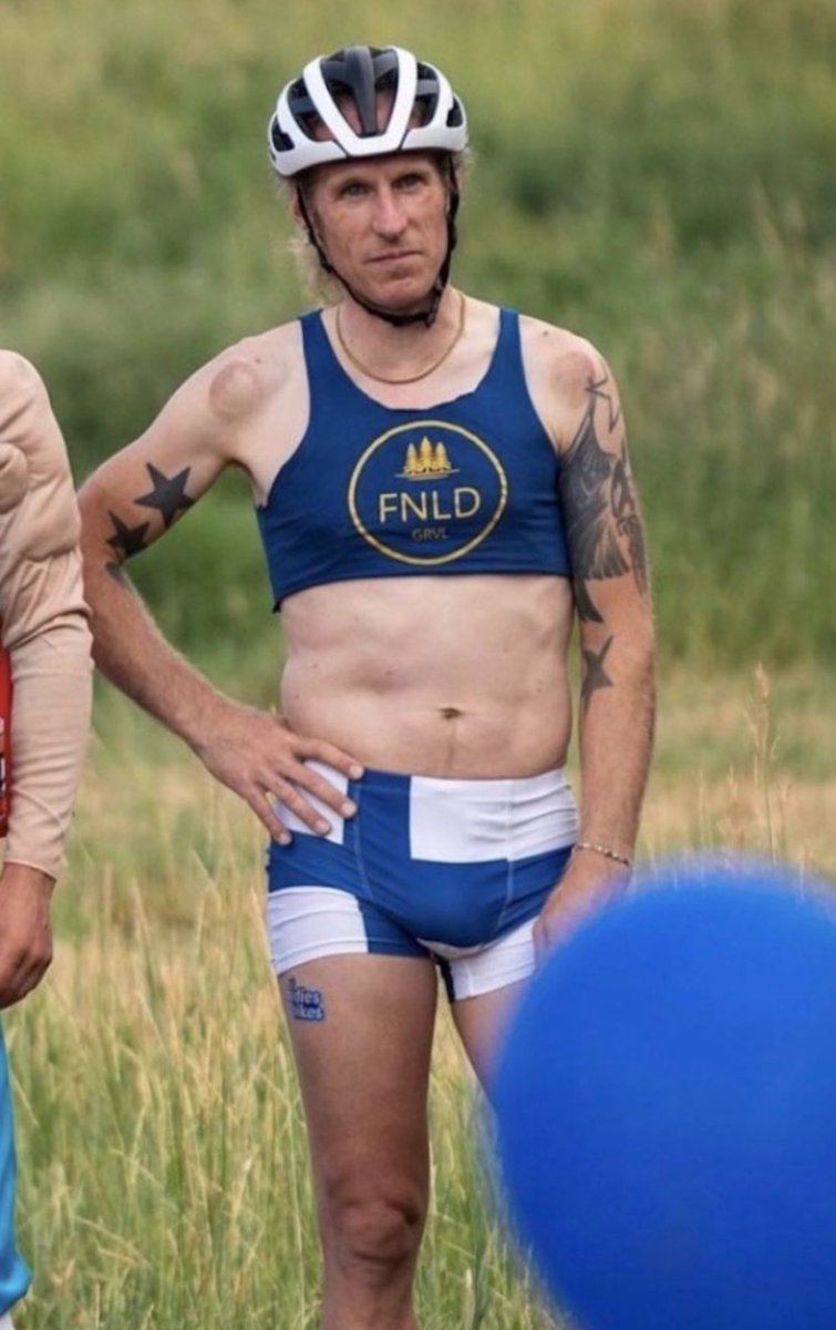 sappholives83's tweet photo. This is “Molly” Cameron. “Molly” is a cyclist who competes in women’s events. Why? Because “Molly” likes to win.

I have eyes. You have eyes. Even #trans activists have eyes. And we all know that “Molly” is a man. Yet here he is, sports bra firmly over his self-induced gynecomastia, and his - HIS - penis on full display, about to steal the first-place trophy and knock every real woman down a place in the rankings.

Why is this allowed? How can anyone look at this picture and say in good faith that this is a woman? 

They can’t. 

They’re lying to us, and they’re lying to themselves - and deep down, they know that. That’s why they get so angry when you confront them with the truth. I don’t get mad when some TRA calls me a man. It’s ridiculous, not offensive. 

Real women don’t care about being misgendered because we aren’t walking around in a fantasyland that can be destroyed by the word “sir.” 

This man has no place in women’s sports. None of them do, and my appreciation goes out to those organizations that have chosen to stand up for the female athletes they were created to serve. Now it’s time for the rest of them to do the same. 

Reality is calling, ladies and gentlemen. I think we should answer the phone.

#SaveWomensSports 
#TransWomenAreConMen 
#WomensRightsAreHumanRights 
#BornNotWorn
#womanface