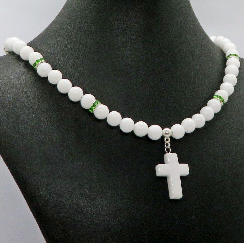 Discover the beauty of White Jade Gemstone Cross Pendant with Peridot Crystals on a White Jade Necklace. A perfect Christmas Prayer accessory from RivendellRocksSedona. #ChristianJewelry #GemstoneNecklace buff.ly/3t8O06O