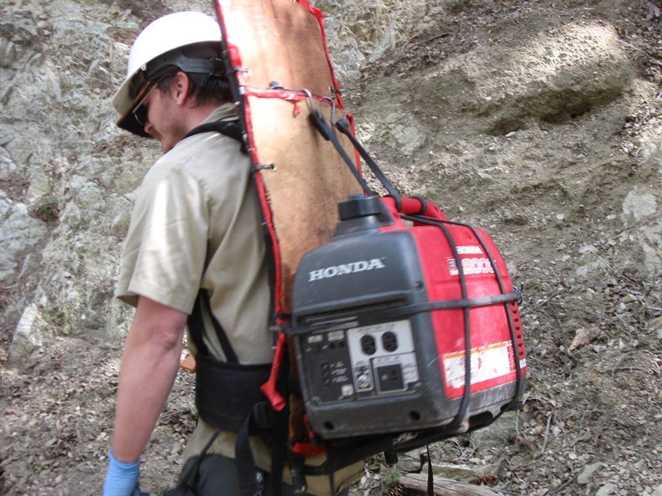 Bryan hiking a 40 pound gasoline powered electric generator up and down the mountain :) Volunteers have fun! ... 'fun' :)