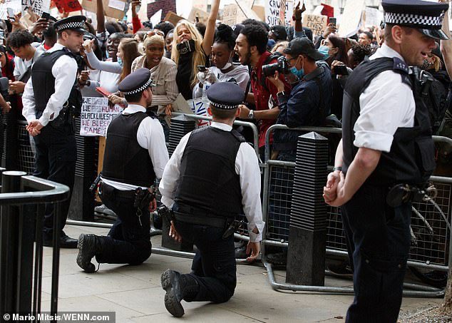 ArchRose90's tweet photo. Spot the odd one out. The Met Police:

Taking the knee for BLM instead of making arrests.

Giving water to an eco activist blocking the road. 

Standing around watching a Palestine activist climb a monument with flares.

Using horses and batons against St George’s Day marchers. https://t.co/RKBnyYIVPN