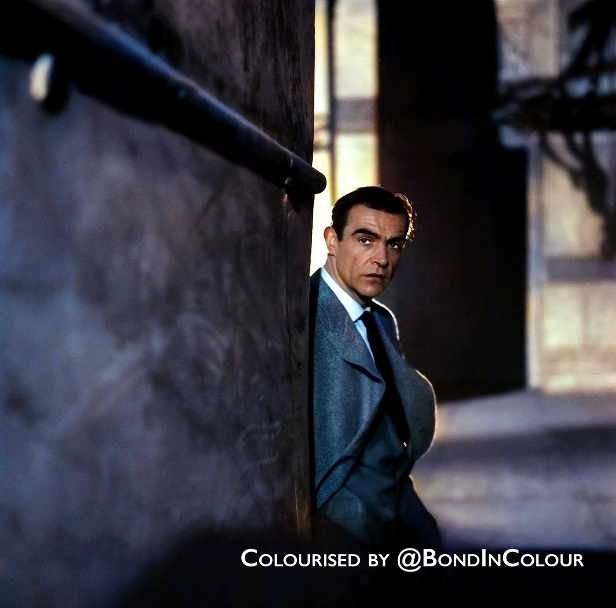 BondinColour's tweet photo. Sean Connery at the Hagia Sophia, Istanbul, Turkey during filming for From Russia With Love. What’s interesting here for style folks is that he appears to be wearing a coat over his suit, something we don’t see in the film. #bond #jamesbond #seanconnery #frwl  #colourised https://t.co/CUAJS0g3jL