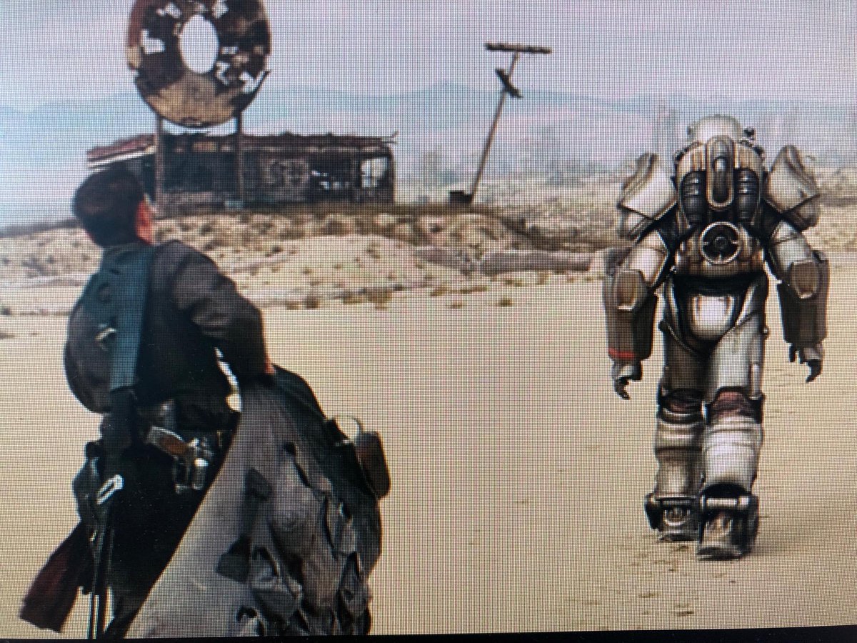 Vograx's tweet photo. Please tell me the huge bag and equipment the squire has to carry is an in-joke about how gamers dump all their loot on their follower.

#FalloutOnPrime #Fallout #SwornToCarryYourBurdens #Bethesda https://t.co/omIeW7P1Jv
