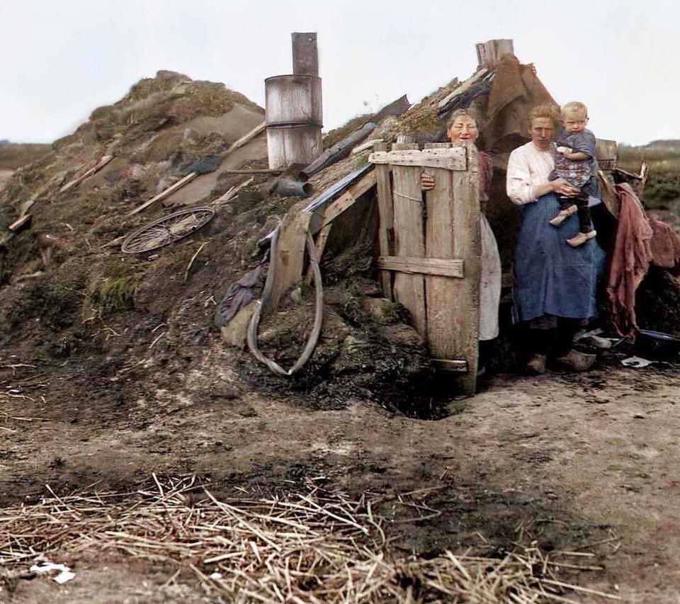 Occupants of a sod house in Drenthe, the Netherlands, photographed standing outside in 1936.