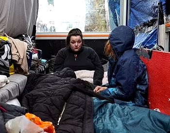 British homeless family forced to live in a bus shelter because they cannot afford basic living expenses. 

A young woman, her partner and her disabled mother were previously sleeping under a shop doorway but were forced to move by police in Birmingham, UK. 

They took shelter in