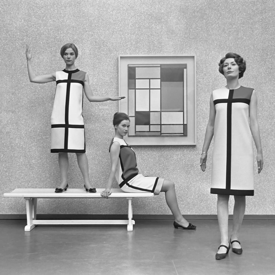 Mondrian inspired dresses by Yves Saint Laurent shown with a Mondrian painting in 1966.