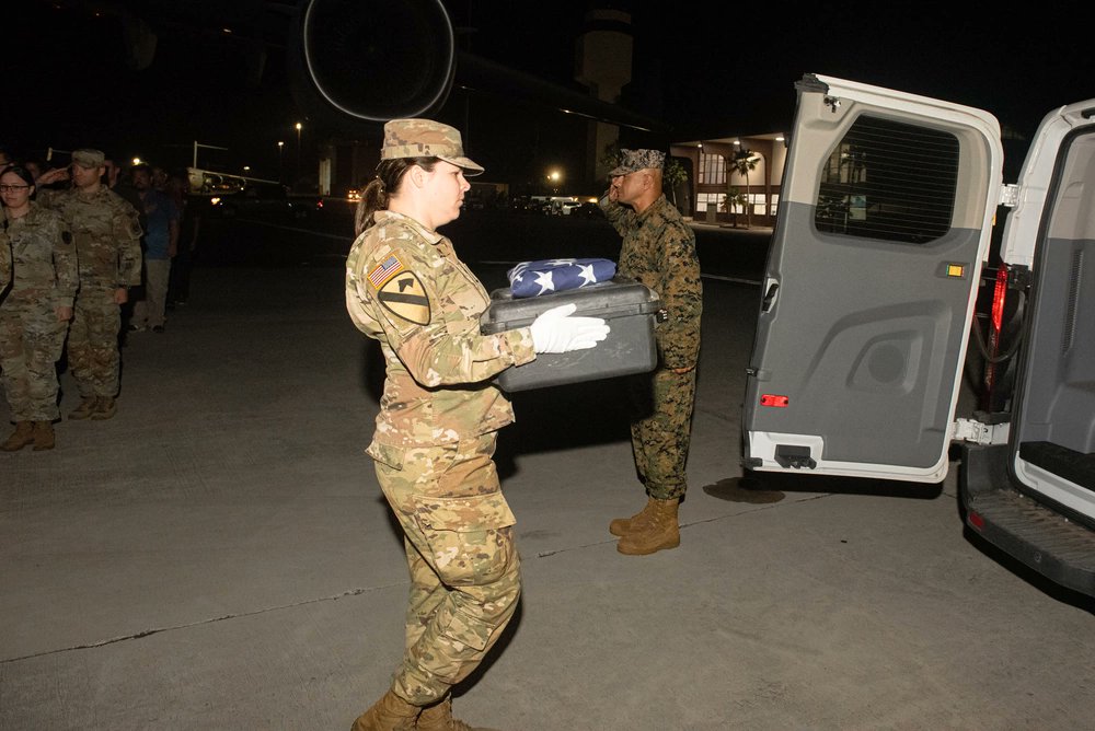 U.S. Army Staff Sgt. Sarah Lindsey, DPAA mission planner, carries a case during an honorable carry ceremony at Joint Base Pearl Harbor-Hickam, Hawaii. The ceremony involved the transfer of a case containing possible osseous material found during a recovery mission in Vietnam.