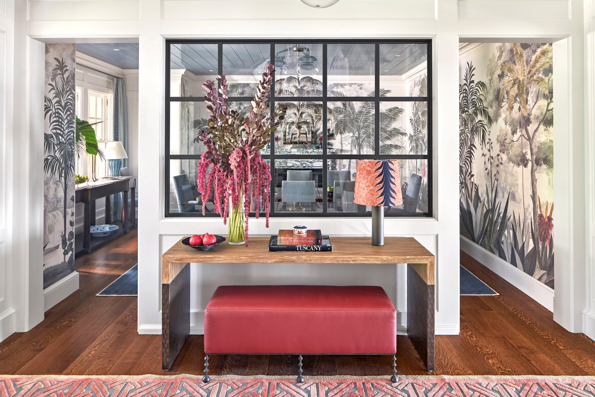 In this new home, an interior steel window provides the perfect blend of an open floor and a defined dining room. Features include integrated paneling, rift and quartered white oak flooring and vibrant splashes of color. #homedesign #architecture #tropical #interiordesign