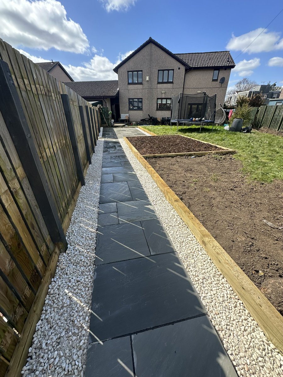Stage one of this garden project completed this week. Grey indian sandstone patio and pathway that will lead to a decking area in the future. Created a kids play area and finished off with a white gravel edging all round.