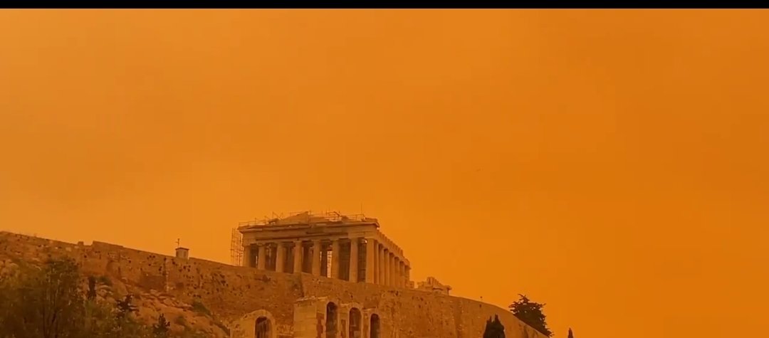 Athens' Acropolis today. Sahara desert dust has turned the sky orange. Blade Runner 2049 effect.