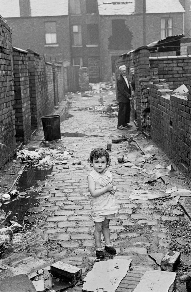 Child in a back alley, Manchester, 1972, by Nick Hedges. (What I would have called a back entry).