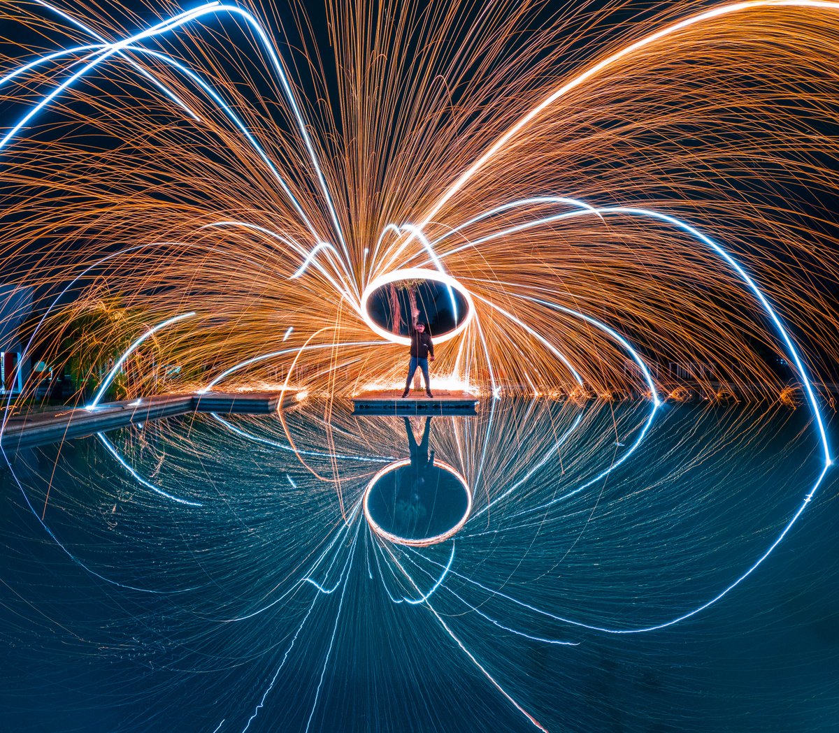 Photo of the Day: Playing with fire 🔥 Captured with Night Photo Mode on #GoProHERO12 Black by Kami Pastrana for a $500 GoPro Award. #GoPro #GoProAwards #LongExposure #SteelWool #Reflection #Pyrotechnics