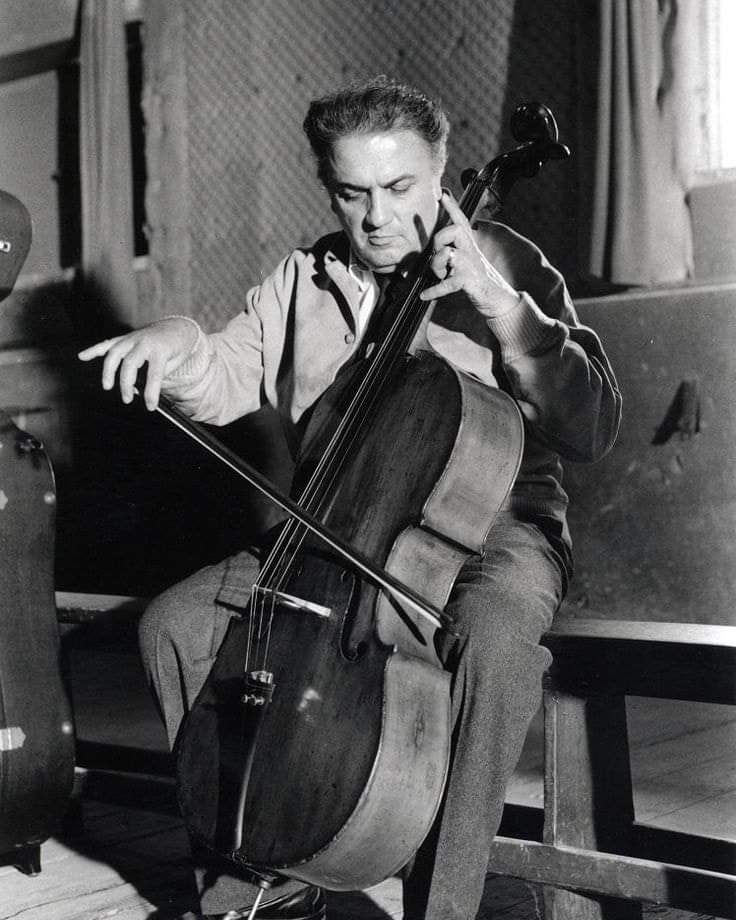Federico Fellini playing the cello, 1965.