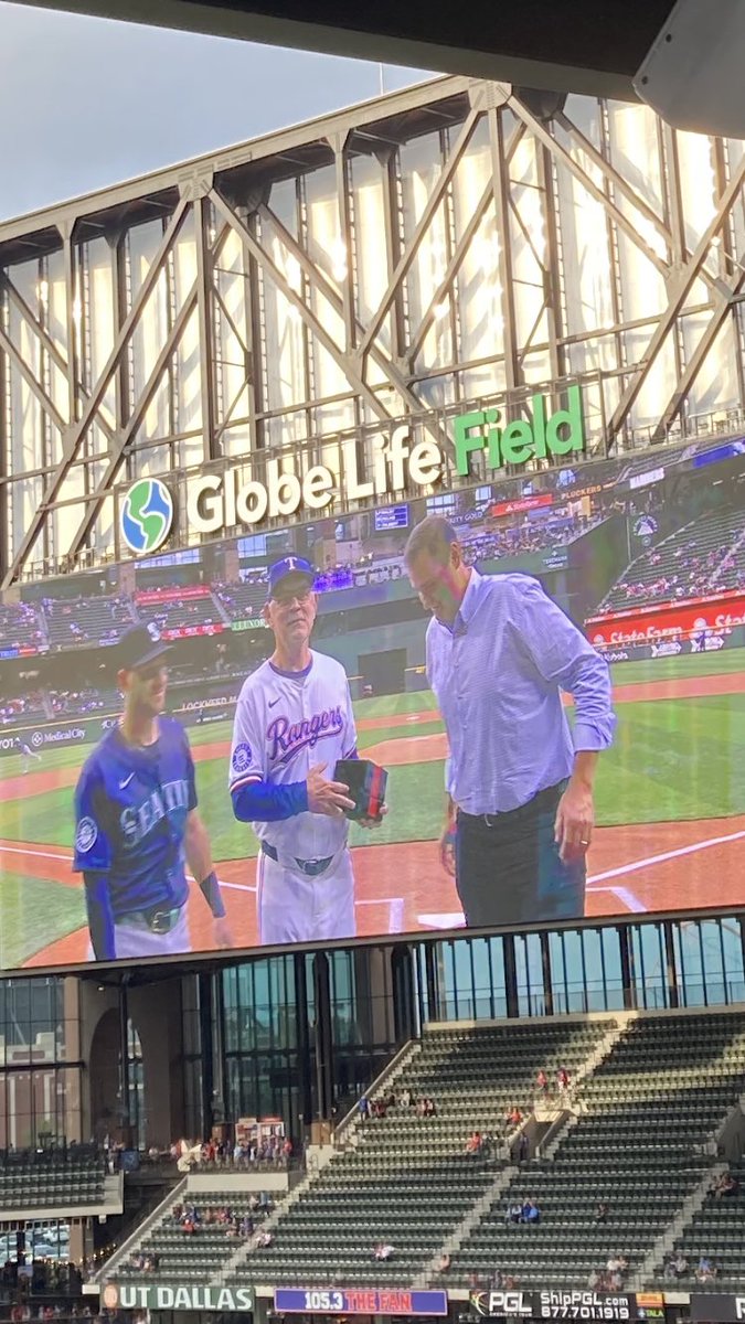 Seattle Mariners DH Mitch Garver receiving his 2023 World Series ring from Rangers Manager Bruce Bochy and General Manager Chris Young prior to first pitch.
