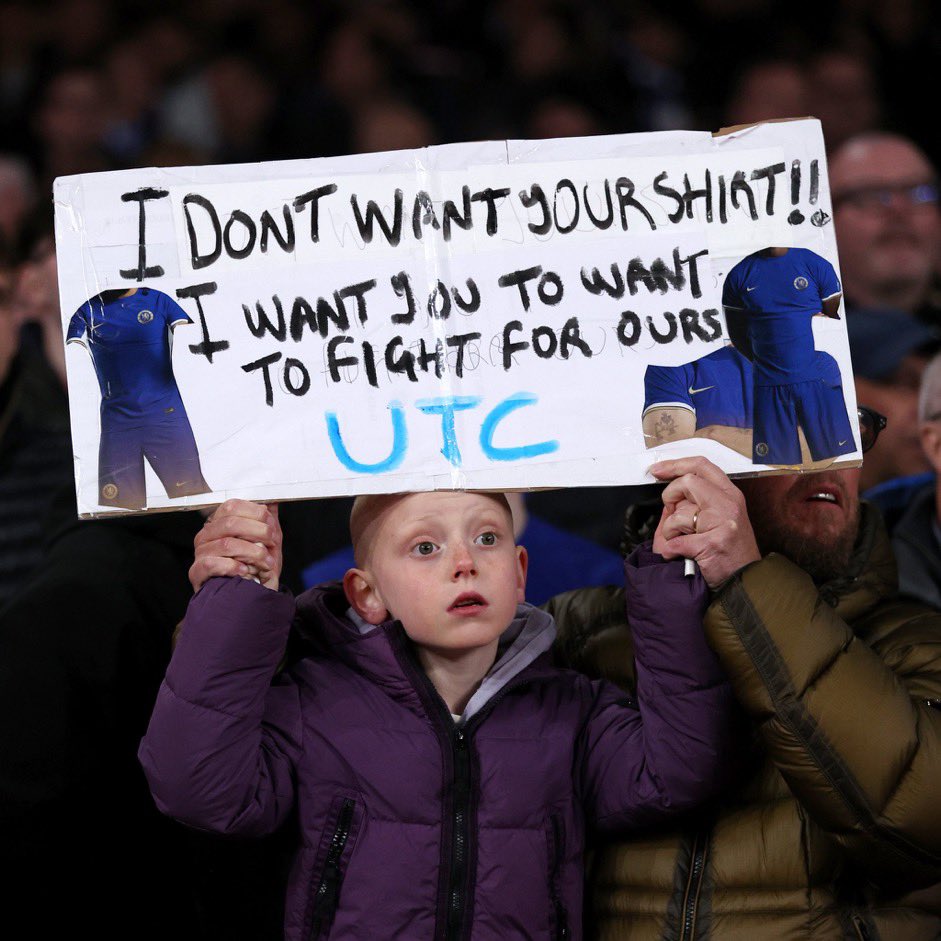 A young Chelsea fan holds the banner that reads: 'I don't want your jersey. I want you to fight for ours.'😭