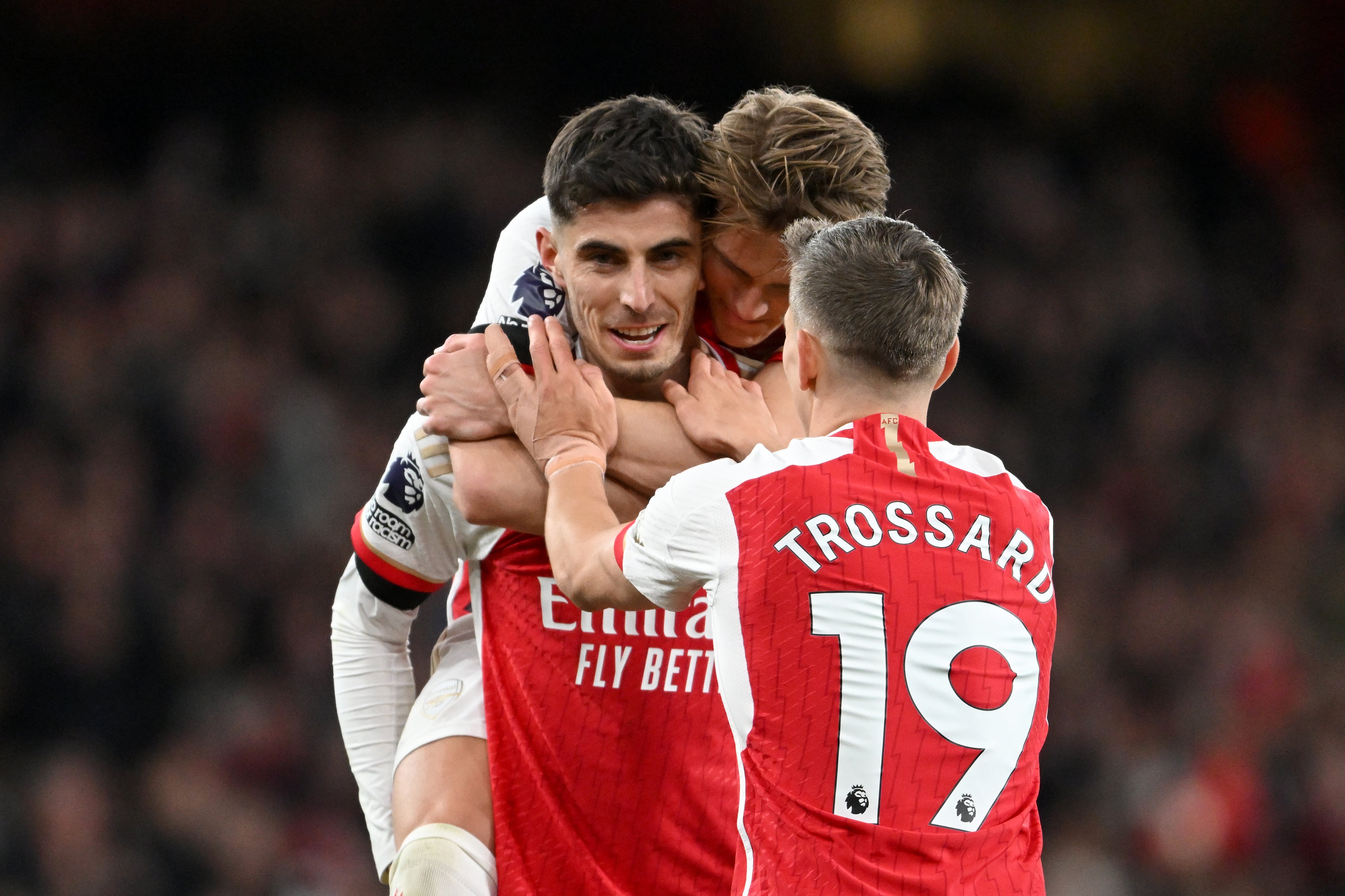 Martin Odegaard and Leandro Trossard celebrate with Kai Havertz.