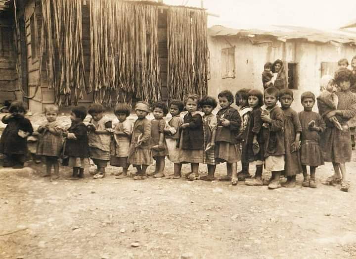 Armenian orphans who survived the Armenian Genocide A group of Armenian orphans, each one holding a piece of bread in his hand, in a refugee camp. 💔🕊️ #ArmenianGenocide