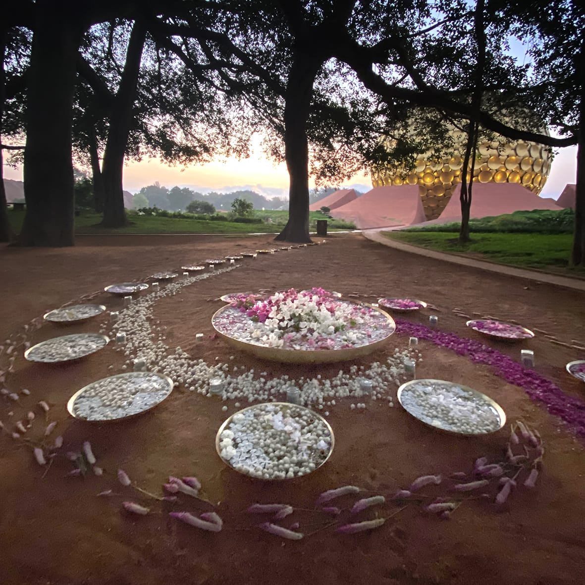 Today, April 24th, in 1920, saw the Mother's definitive return to Pondicherry to join Sri Aurobindo and His work for the future of humanity. Meditation under the Banyan Tree, Matrimandir, with the flower decoration as an offering 🪷 #Auroville #SriAurobindo #TheMother