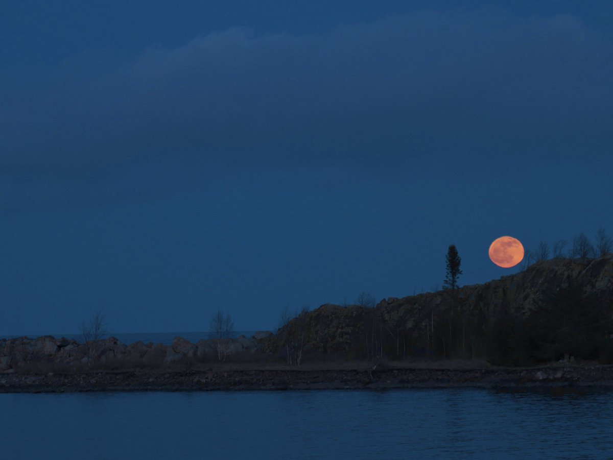 Pink moon rising over Gull Island on Lake Superior