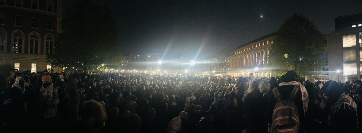 It’s almost midnight and turnout of students at @Columbia has filled the entire plaza. Students being divided into groups to deter NYPD movement into encampment.