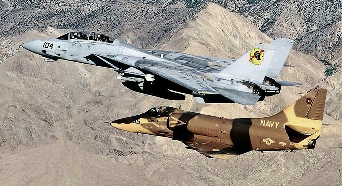 Compact, hard-hitting, and beautifully engineered, the A-4 Skyhawk was one of the world's most cost-effective fighters ever produced. Here's a #USNavy A-4 in the guise of an agressor, flying next to a mighty F-14 (Circe 90s). #avgeeks #aviation #aviationdaily