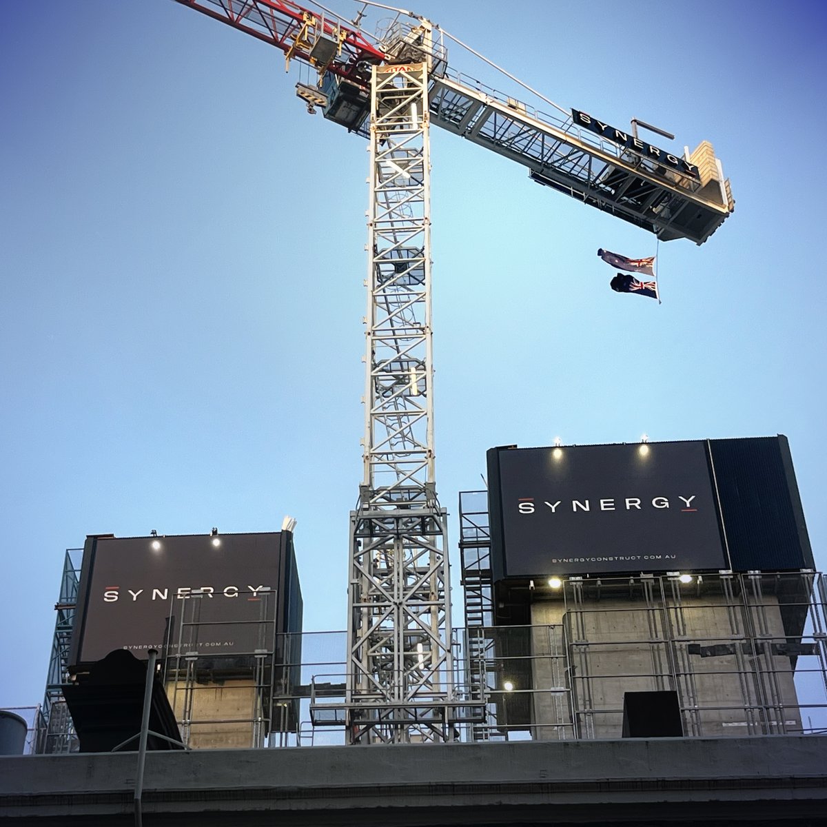 SynrgyConstruct's tweet photo. On this ANZAC Day, we honour the bravery of all those who served and paid the ultimate sacrifice. As a symbol of respect, we are proudly flying both the Australian and New Zealand flags on our cranes. Today, we stand together in solidarity and gratitude. Lest we forget. https://t.co/pPN7GB68sC